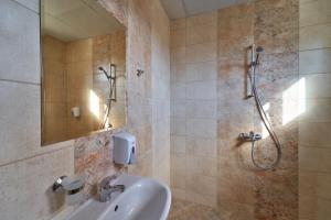 a bathroom with a sink and a shower at Kings View in Veliko Tŭrnovo