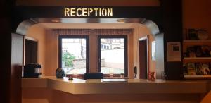 a room with a window with a sign that reads reception at Hotel Baeren in Leimen