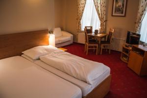 Postel nebo postele na pokoji v ubytování Hotel Roháč