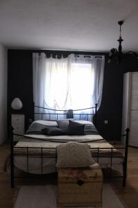 a bedroom with a large bed with a window at Blue Harbour No. 15 in Veli Iž