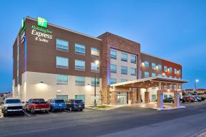 a hotel with cars parked in a parking lot at Holiday Inn Express & Suites El Paso East-Loop 375 by IHG in El Paso