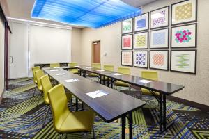 a classroom with long tables and yellow chairs at Holiday Inn Express & Suites El Paso East-Loop 375 by IHG in El Paso +39 photos