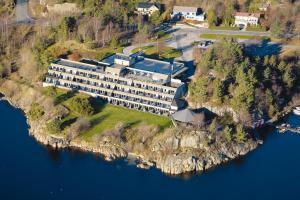 an aerial view of a building on an island in the water at Farsund Fjordhotel in Farsund