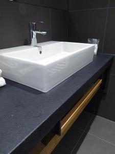a white sink on a counter in a bathroom at Berghotel Sammüller in Neumarkt in der Oberpfalz