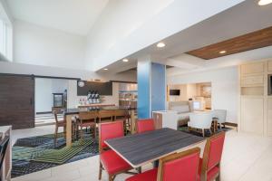 an open kitchen and dining room with a table and chairs at Holiday Inn Express Hotel & Suites Frankfort, an IHG Hotel in Frankfort