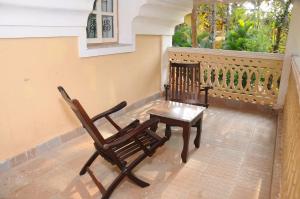 a pair of chairs and a table on a balcony at Palolem Guest House in Palolem