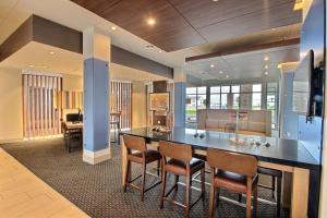 a kitchen with a table and chairs in a room at Holiday Inn Express & Suites Fond Du Lac by IHG in Fond du Lac