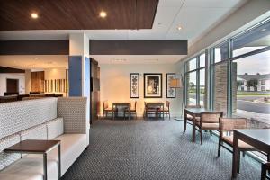 a living room filled with furniture and a large window at Holiday Inn Express & Suites Fond Du Lac, an IHG Hotel in Fond du Lac