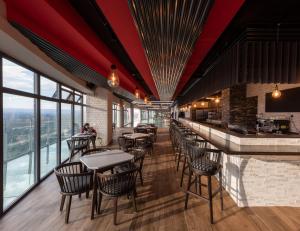 a restaurant with tables and chairs and a bar at Prime Living Luxury Apartments in Nairobi
