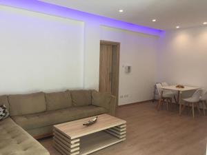 a living room with a couch and a table at Modern 2 bedroom Beach Apartment in Limassol