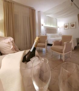 um quarto com uma garrafa de champanhe e duas taças de vinho em Le Nicchie Guest House em Lucera