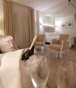 una habitación con una botella de champán y dos copas de vino en Le Nicchie Guest House, en Lucera