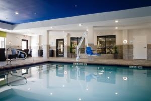 a swimming pool in a hotel lobby with a swimming pool at Holiday Inn Express El Reno, an IHG Hotel in El Reno