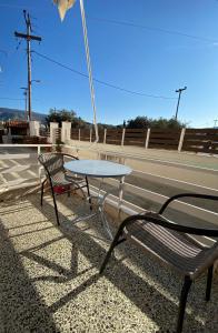 a table and a bench on the side of a road at Mpanos Sea Apartment 1 in Loutra Oraias Elenis