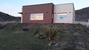 uma casa numa colina com duas janelas em Lugar de PAZ en las Sierras em Sierra de la Ventana