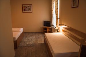 Postel nebo postele na pokoji v ubytování Hotel Roháč