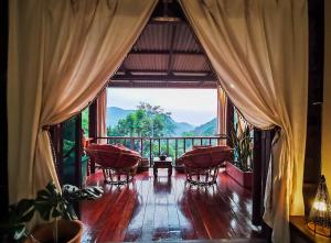 a room with a balcony with a view of mountains at ทโล้ โฮมสเตย์ เชียงใหม่ | Taloh Homestay Chiangmai in Mae On