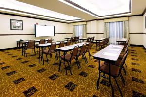 a conference room with tables and chairs and a screen at Holiday Inn Express Fresno Northwest - Herndon, an IHG Hotel in Herndon