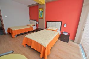 Postel nebo postele na pokoji v ubytování Plaza Sur Hotel & Suites