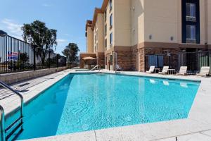 a swimming pool in front of a building at Holiday Inn Express Fresno Northwest - Herndon, an IHG Hotel in Herndon