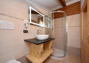 a bathroom with a sink and a shower at Villa Mirabell in Cavalese