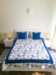 a bedroom with a bed with blue pillows at Appartamento Azzurro Mare in Sestri Levante