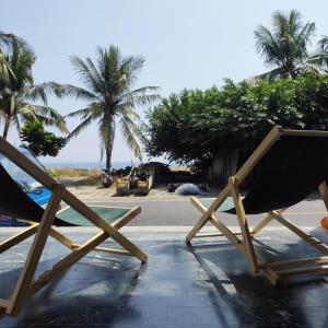um par de cadeiras sentadas ao lado da praia em 琉浪潛水背包客棧 Drift Diving Hostel em Xiaoliuqiu
