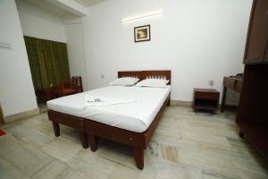 Kairali Tourist Home客房内的一张或多张床位