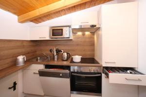 a small kitchen with a sink and a microwave at Edelweiss am See in Zell am See