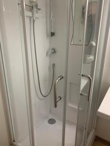a shower with a glass door in a bathroom at Budget Hotel Melun Sud - Dammarie Les Lys in Dammarie-lès-Lys