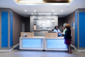 two women standing at a counter in a room at Holiday Inn Express & Suites Florence I-95 & I-20 Civic Ctr by IHG in Florence +51 photos