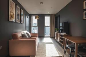 a living room with a couch and a table at The Gate London City in London