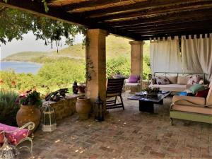 a patio with couches and a view of the water at The Seacret Beachfront Villa in Néa Péramos