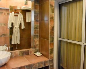 a bathroom with a robe hanging on a wall at Design House Corrientes in Corrientes