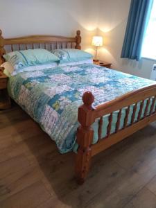 a bedroom with a bed with a wooden bed frame at Rosedene in Mablethorpe