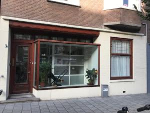 a store front with a large glass window at Ons Nest in Amsterdam