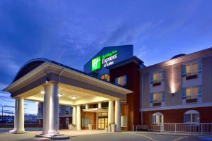 a hotel with a sign on top of it at Holiday Inn Express Hotel & Suites-Hinton, an IHG Hotel in Hinton