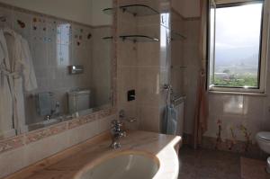 a bathroom with a sink and a shower and a toilet at Villino Lenci in Trappitello +28 photos