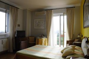 a bedroom with a bed and a large window at Villino Lenci in Trappitello