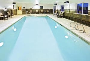 a swimming pool with a pool table and chairs at Hyatt Place Fairbanks in Fairbanks