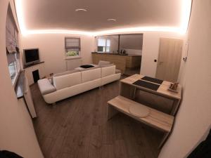 a living room with a white couch and a table at David´s Apartment in Meckenbeuren