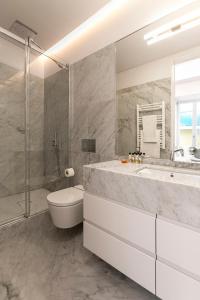 a bathroom with a sink and a toilet and a shower at Casas da Baixa - Unique Chiado in Lisbon