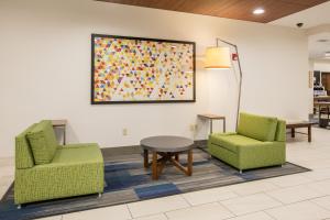 a living room with a couch, chairs and a table at Holiday Inn Express Hotel & Suites Dallas - Grand Prairie I-20, an IHG Hotel in Grand Prairie