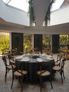 a dining room with a table and chairs and windows at Leśne Patio in Katowice