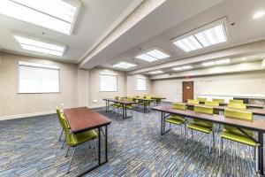 a conference room with tables and chairs and windows at Holiday Inn Express & Suites Fort Worth - Fossil Creek by IHG in Fort Worth