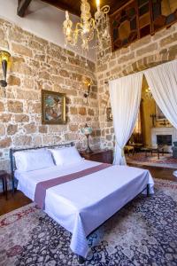 a bedroom with a large bed in a stone wall at CASA DI ALEJANDRO in Rhodes Town