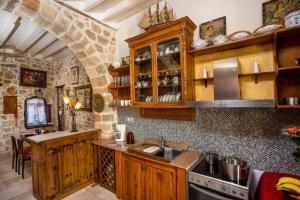 a kitchen with wooden cabinets and a counter top at CASA DI ALEJANDRO in Rhodes Town
