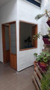 Habitación con puerta, ventana y algunas plantas en Sant Pere Apartment, en Puzol