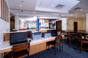 ein Büro mit zwei Computern auf einer Theke mit Stühlen in der Unterkunft Holiday Inn Express & Suites - Gaylord, an IHG Hotel in Gaylord