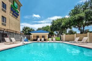 a swimming pool in front of a hotel at Holiday Inn Express Hotel and Suites Fort Worth/I-20 in Fort Worth